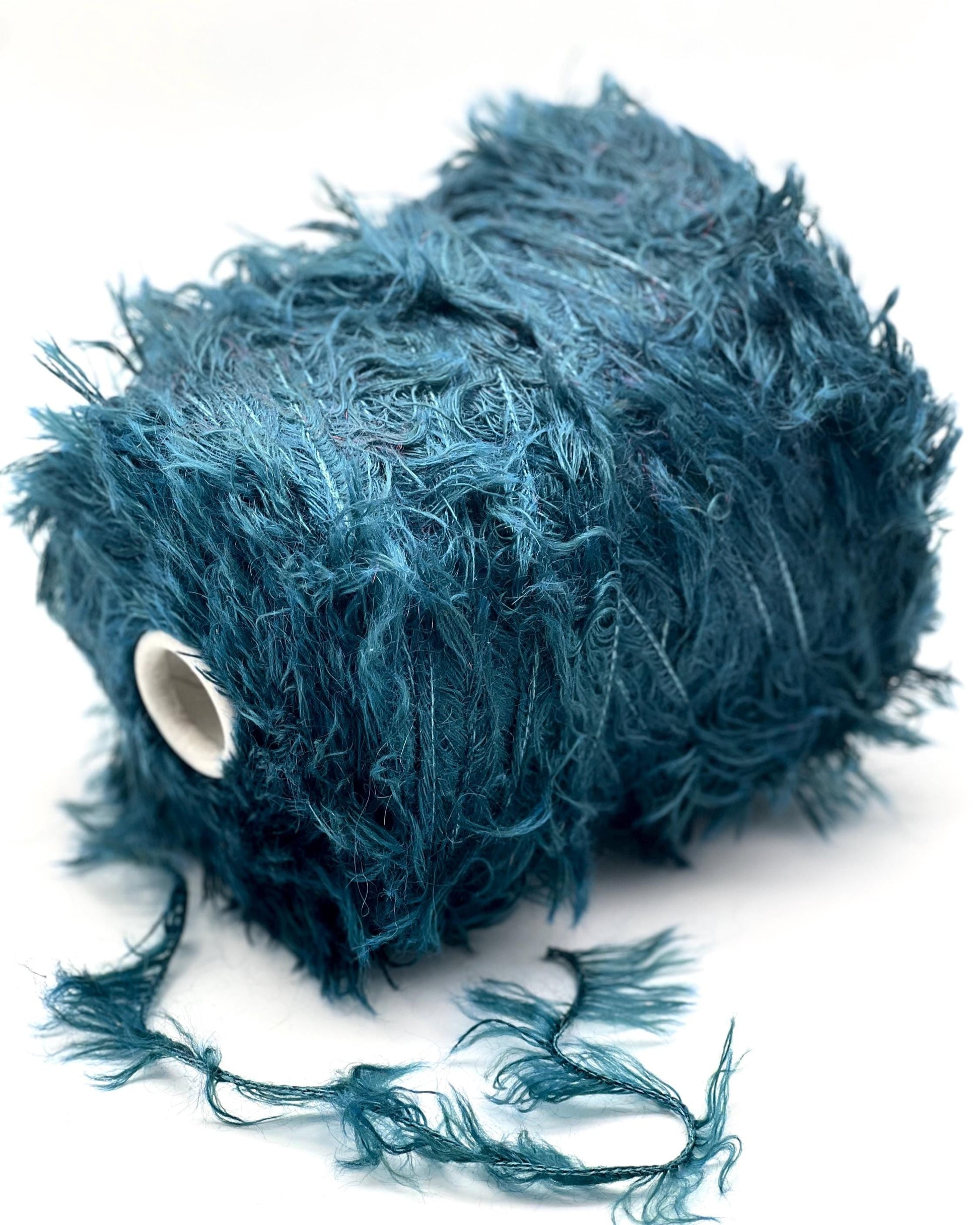 Blue feathered object on a white background
