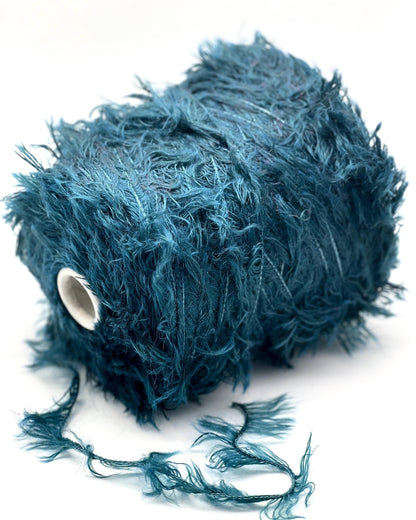 Blue feathered object on a white background