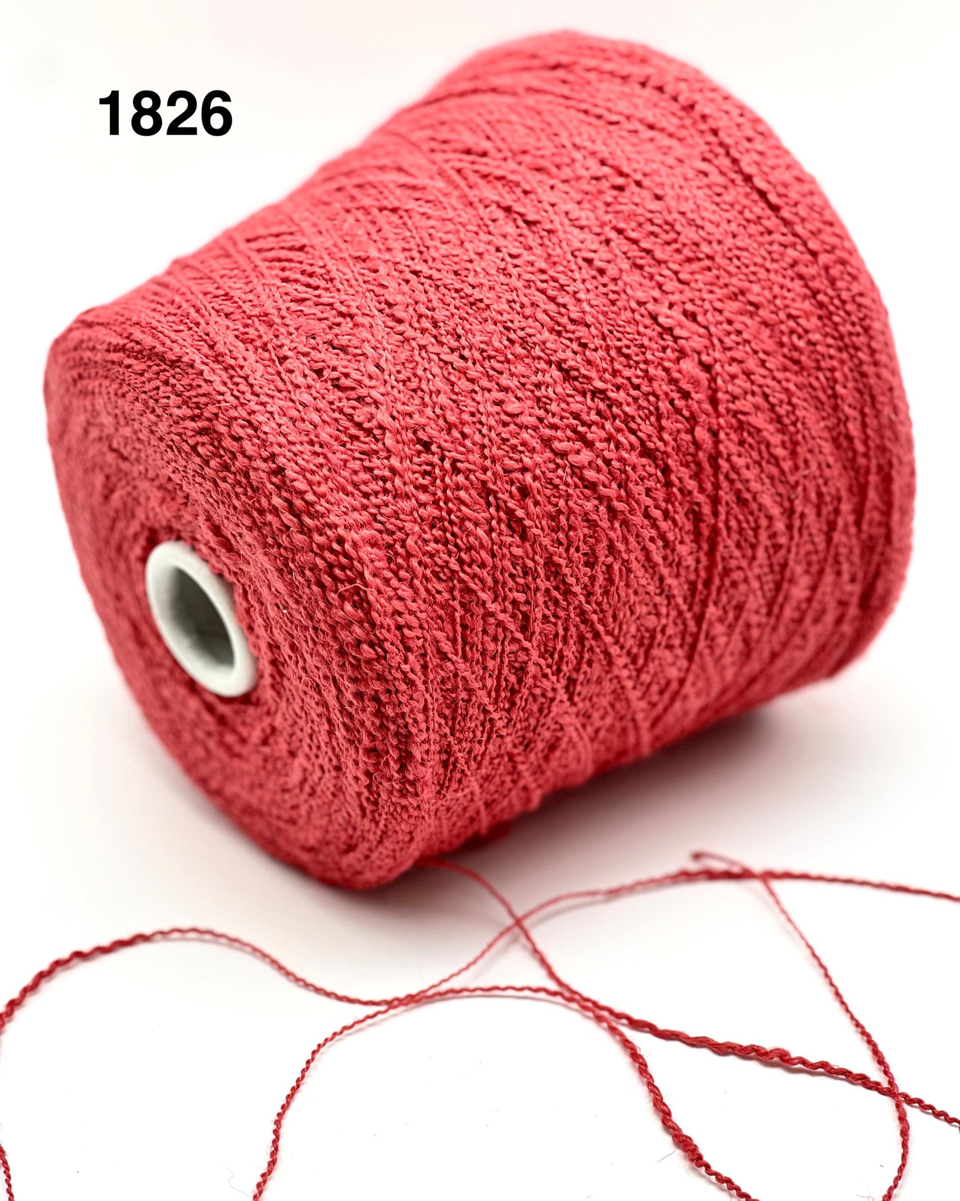 Red spool of yarn on a white background