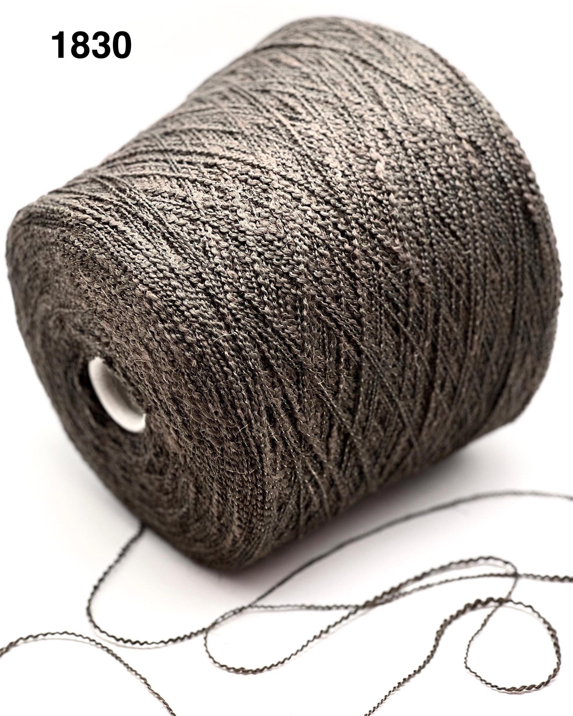 Spool of gray yarn with a white background