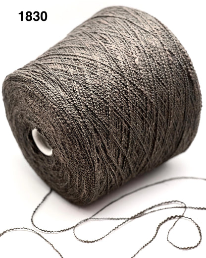 Spool of gray yarn with a white background