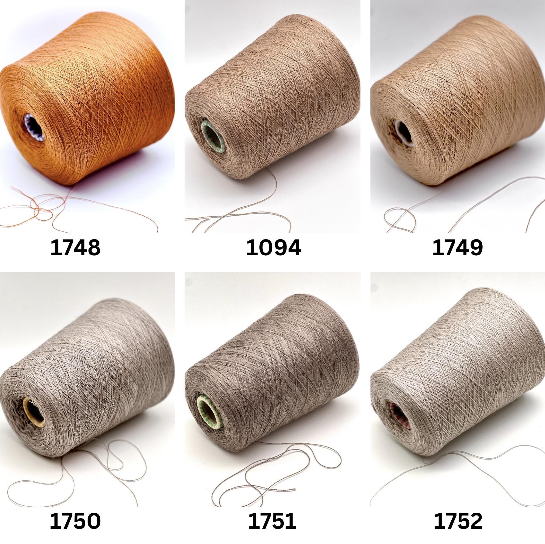 Set of six spools of thread in different colors on a white background