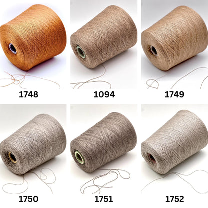 Set of six spools of thread in different colors on a white background