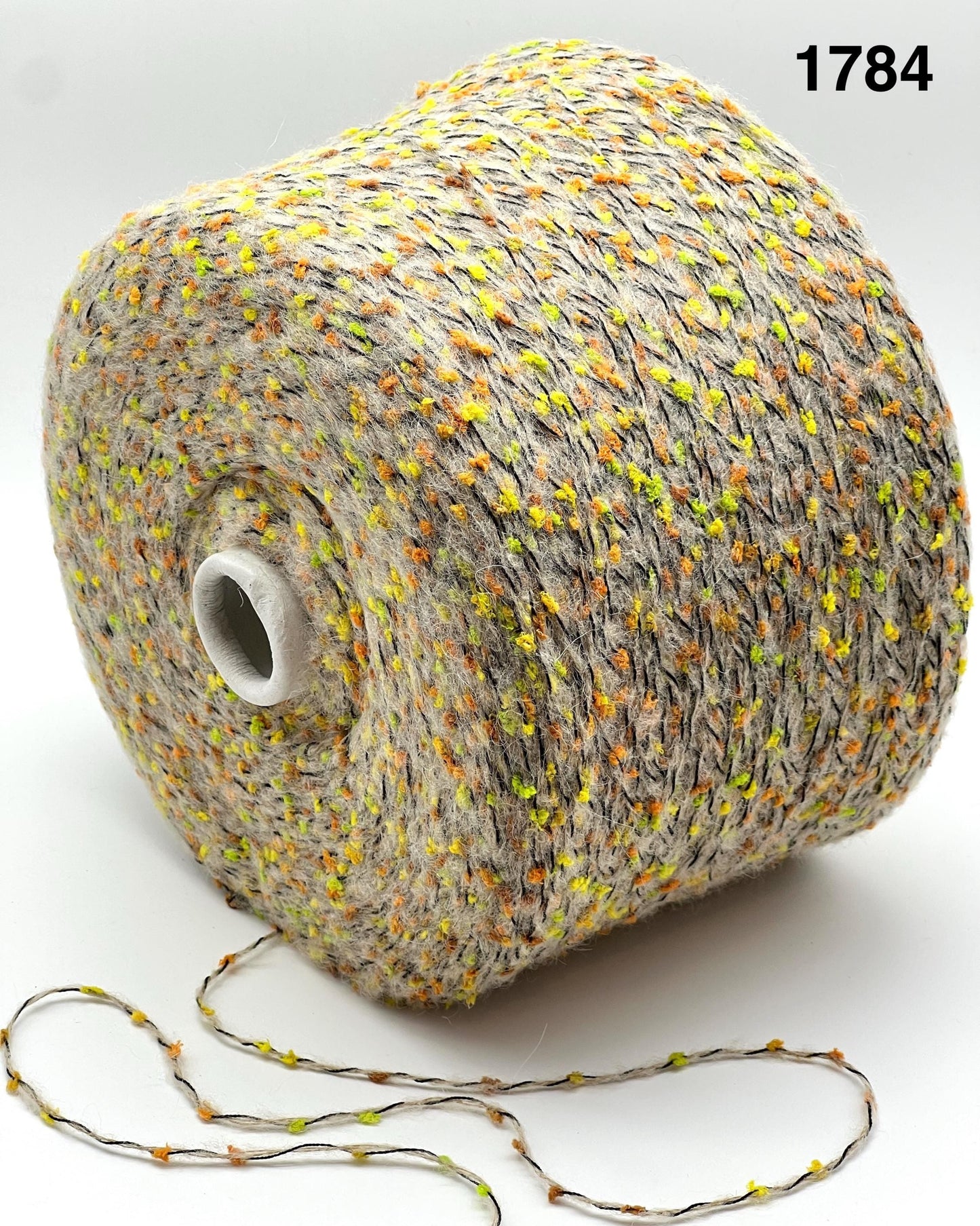 COLOR 1784 BEIGE MULTI - Spool of multicolored yarn on a white background