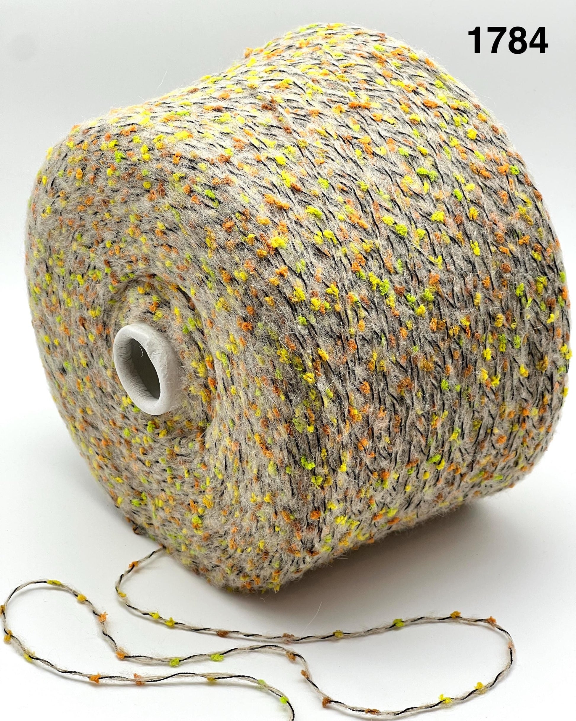 COLOR 1784 BEIGE MULTI - Spool of multicolored yarn on a white background