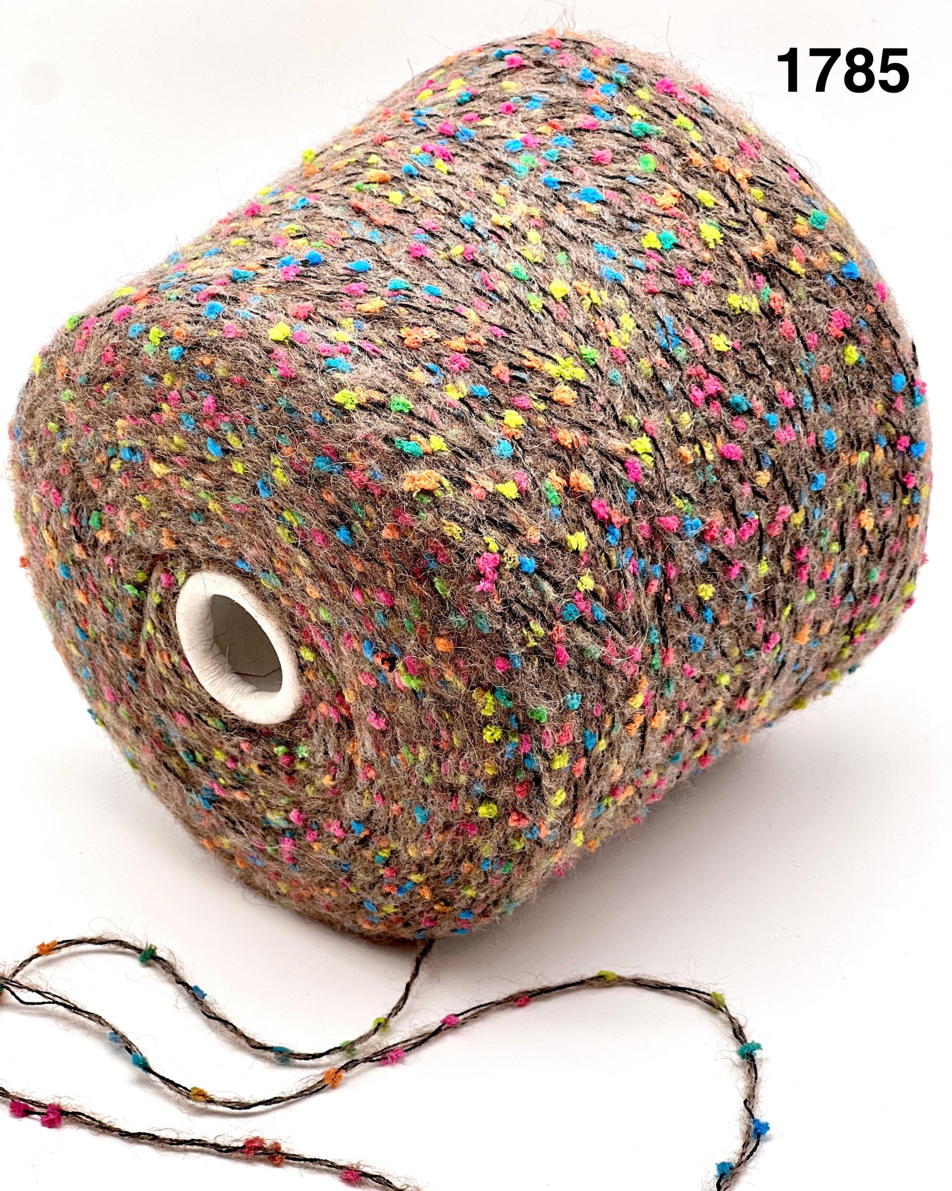 COLOR 1785 COCOA MULTI - Multicolored yarn spool with a small string of yarn on a white background