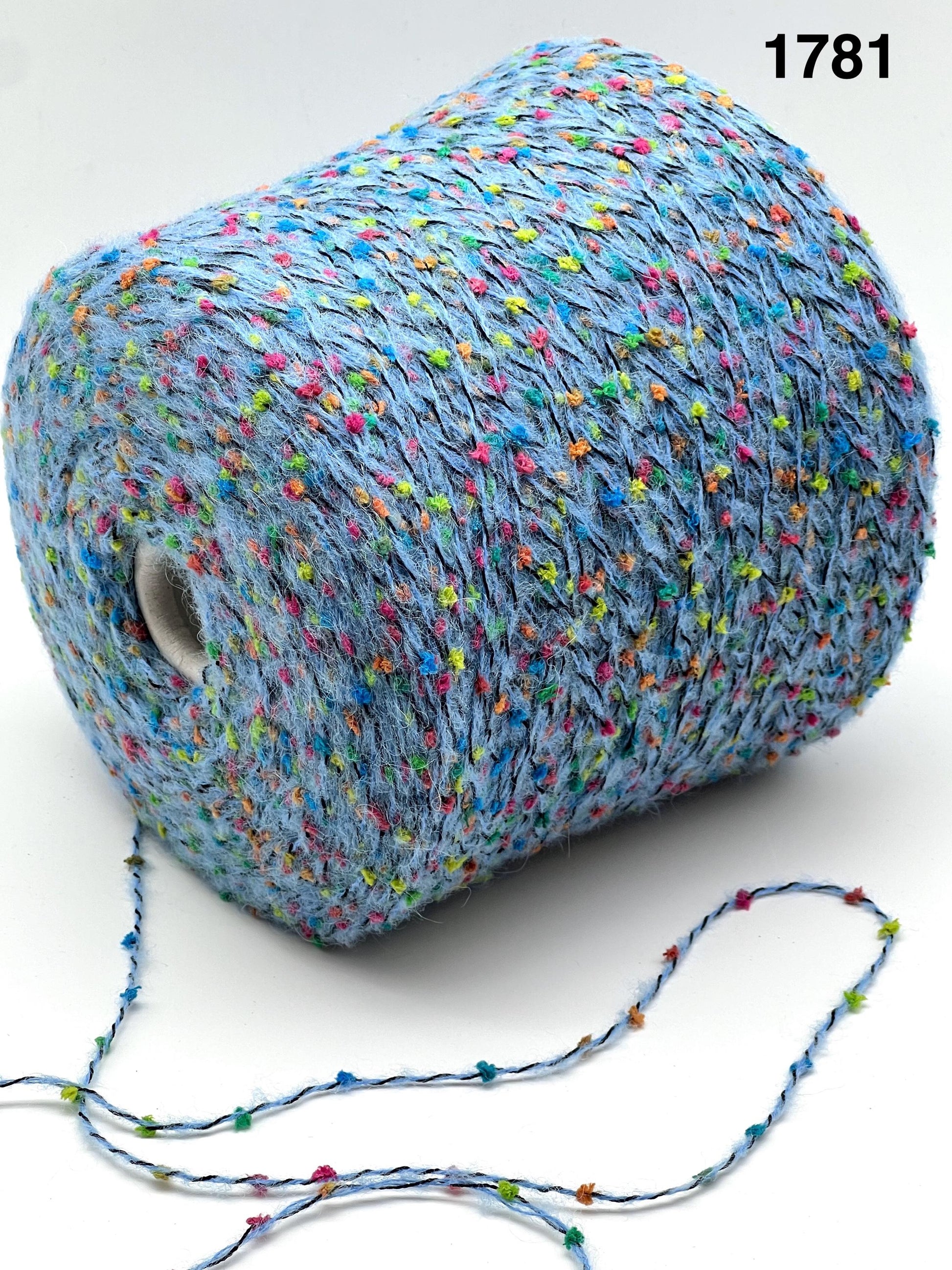 COLOR 1781 BLUE MULTI - Spool of blue yarn with colorful speckles on a white background