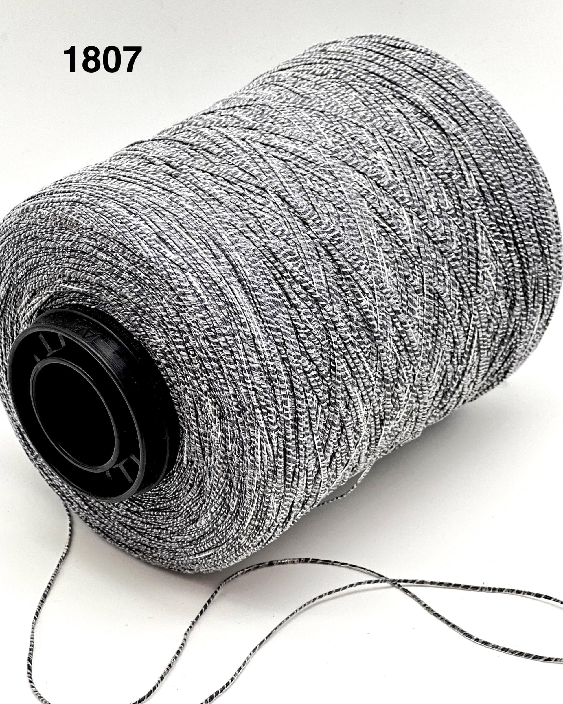 Spool of gray thread on a white background with number 1807.
