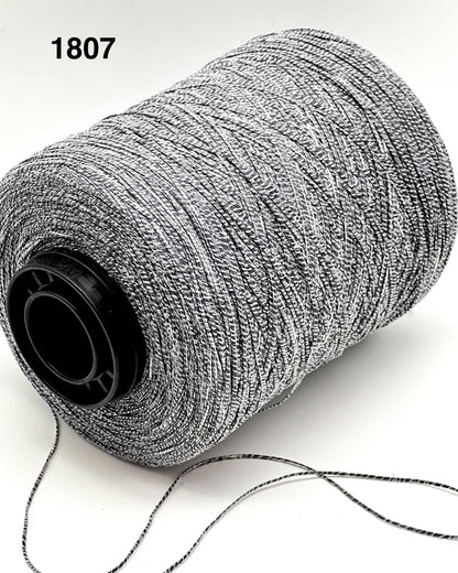 Spool of gray thread on a white background with number 1807.