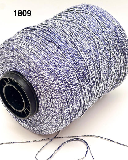 Spool of gray thread with a black core on a white background
