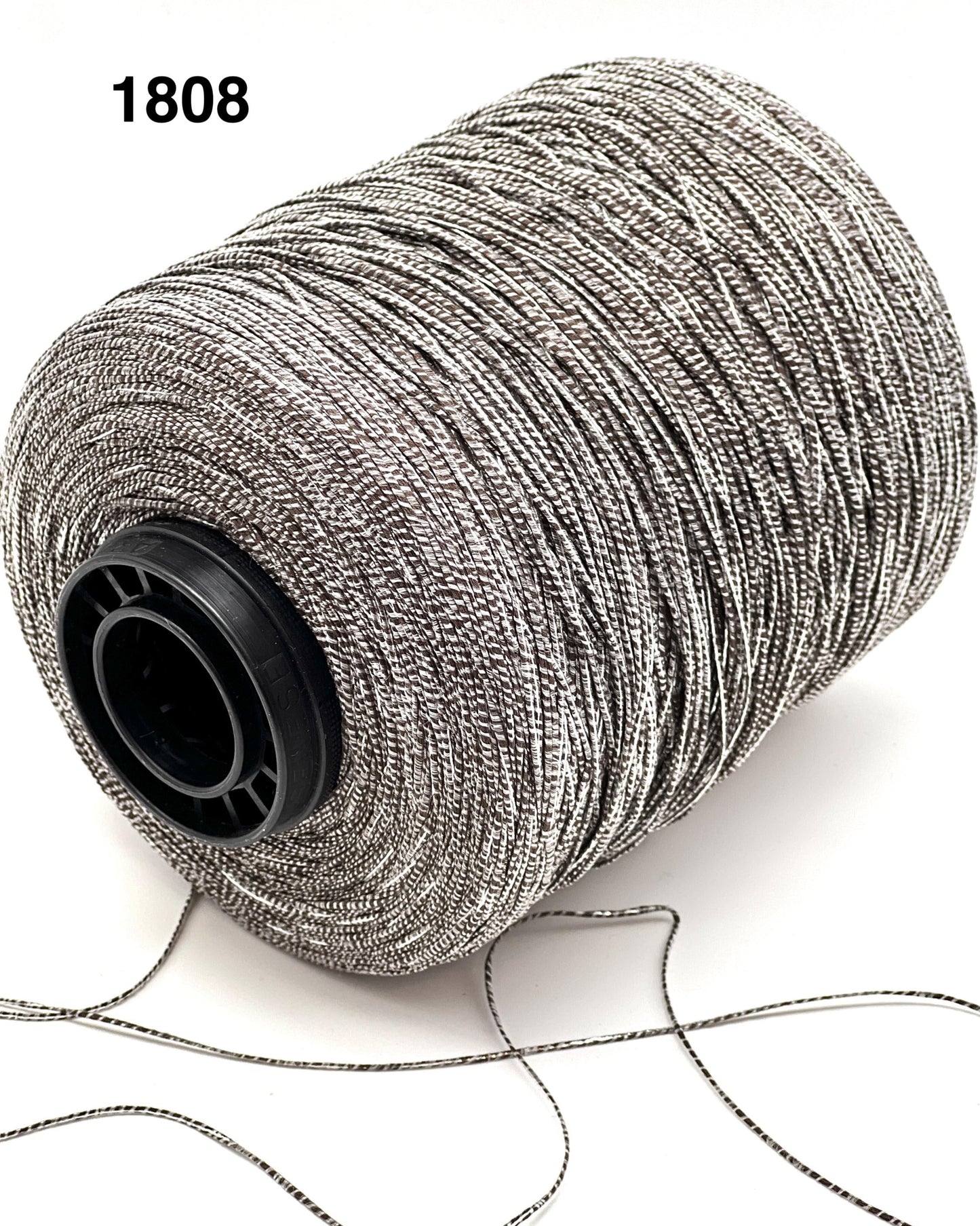 Spool of silver thread on a white background with number 1808.