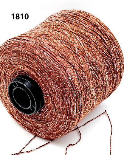 Spool of brown thread with a black spool cap on a white background
