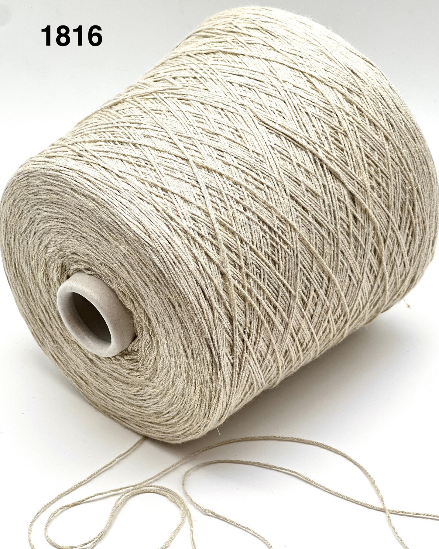 Spool of beige thread on a white background