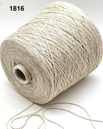 Spool of beige thread on a white background