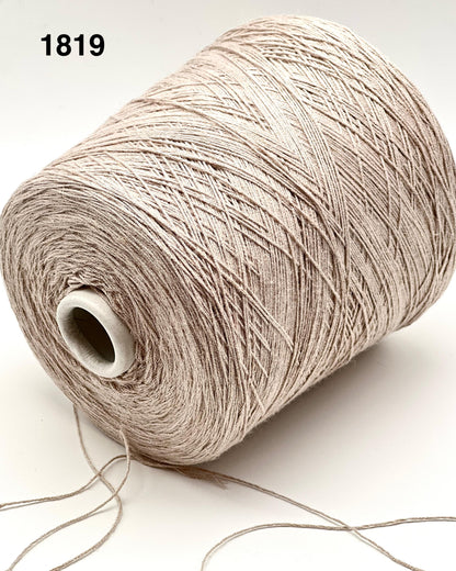 Spool of beige yarn on a white background