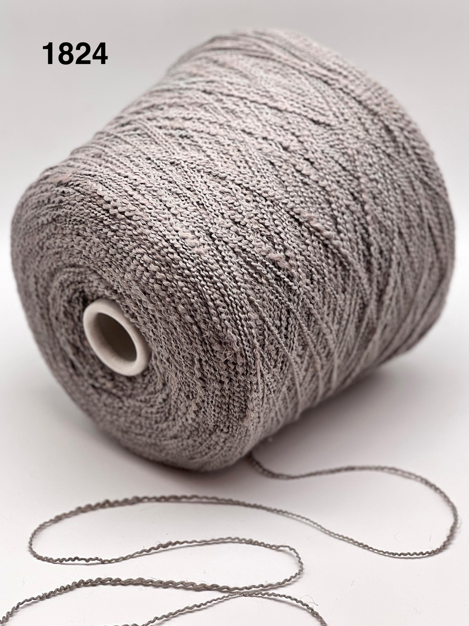 Spool of gray yarn on a white background