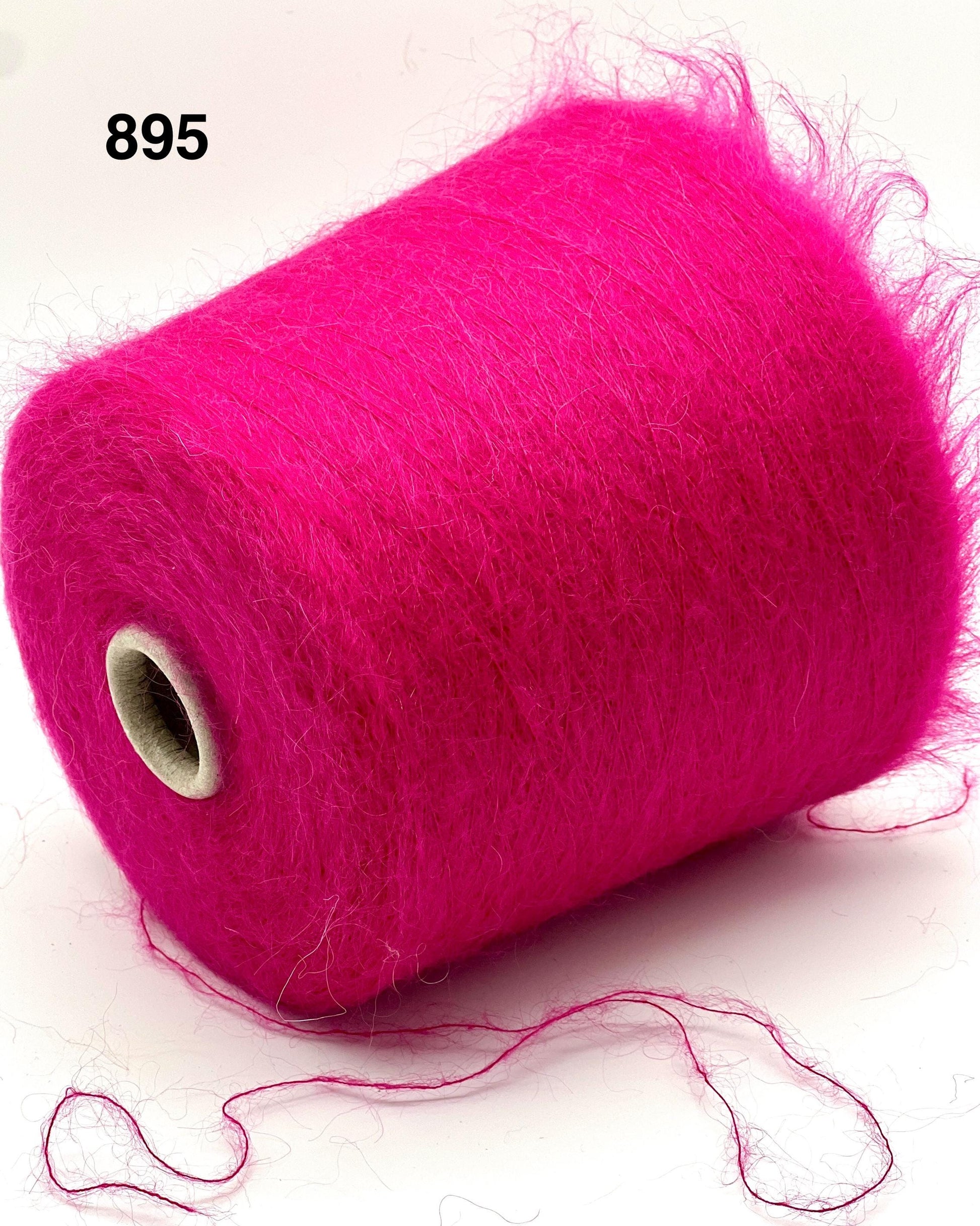 Pink yarn spool on a white background