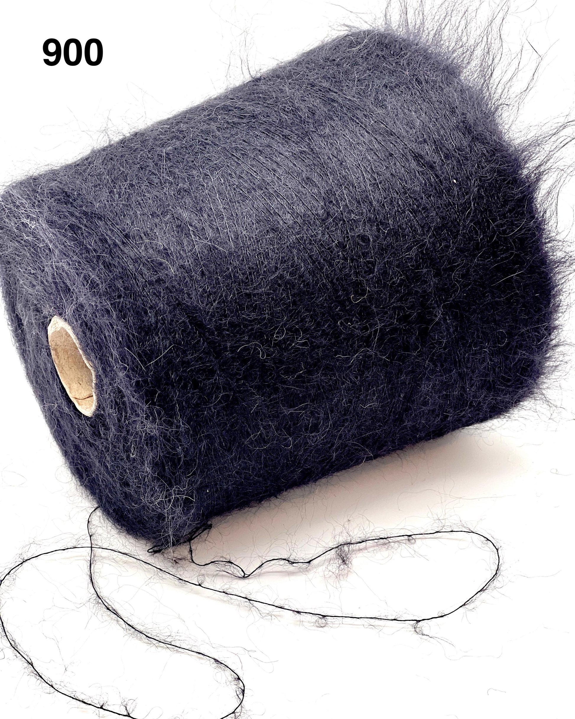 Spool of dark blue yarn on a white background