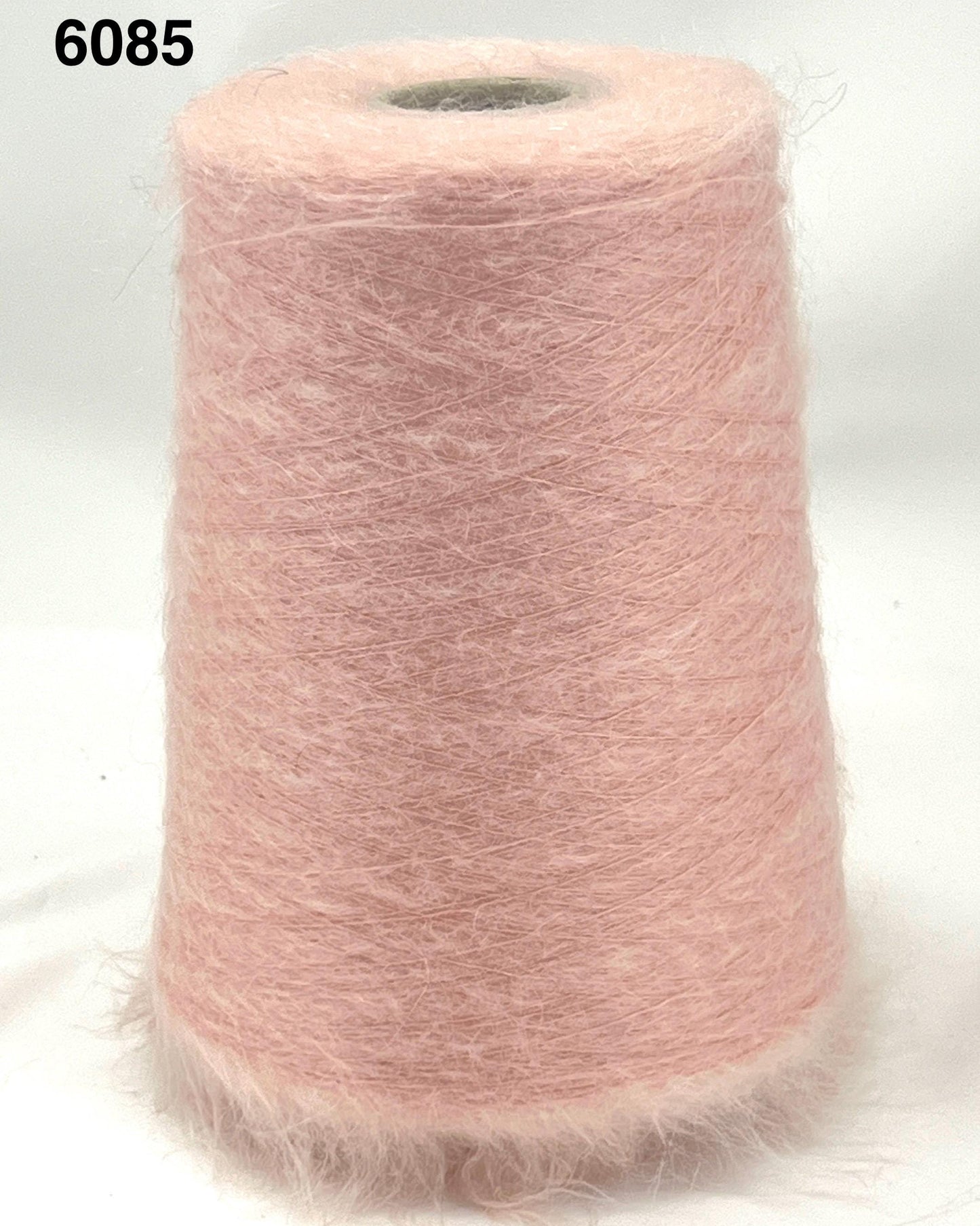 Pink yarn cone on a white background
