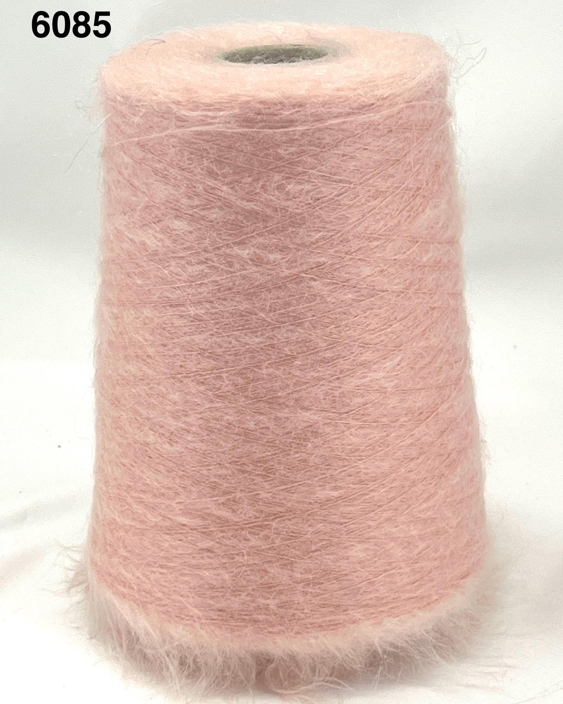 Pink yarn cone on a white background