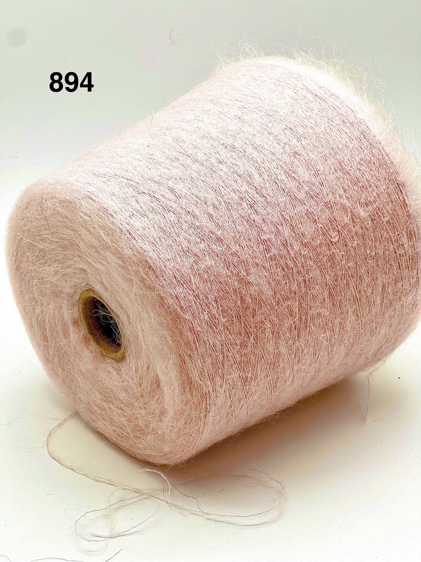 Spool of pink yarn on a white background with number 894.