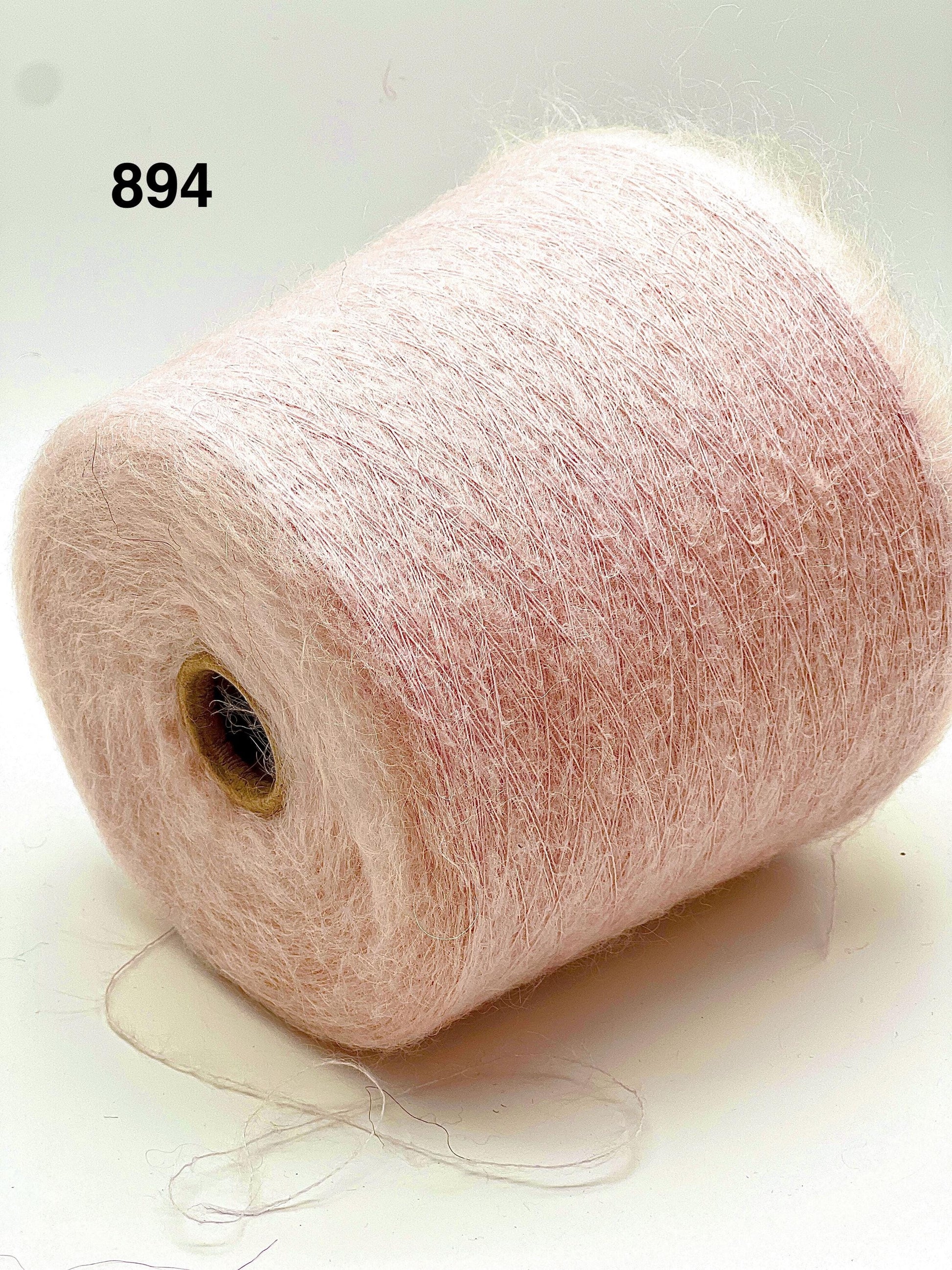 Spool of pink yarn on a white background with number 894.
