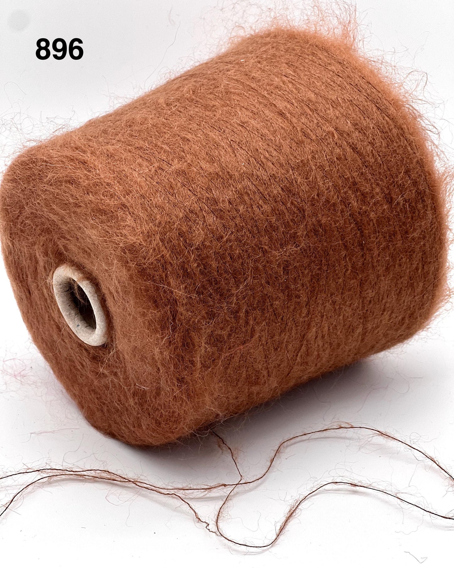 Brown spool of thread on a white background