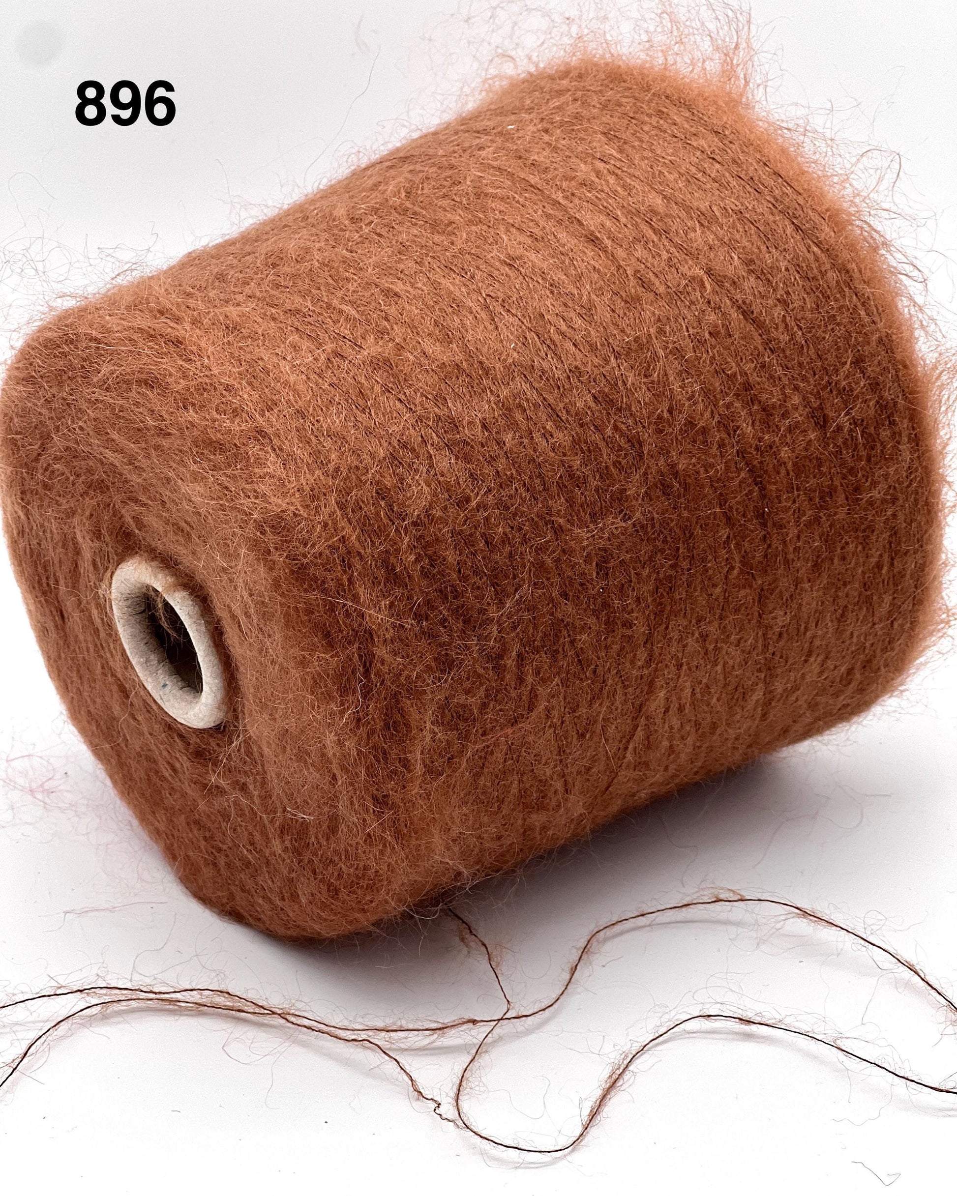 Brown spool of thread on a white background