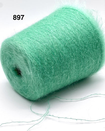 Green yarn roll on a white background with visible thread strands.