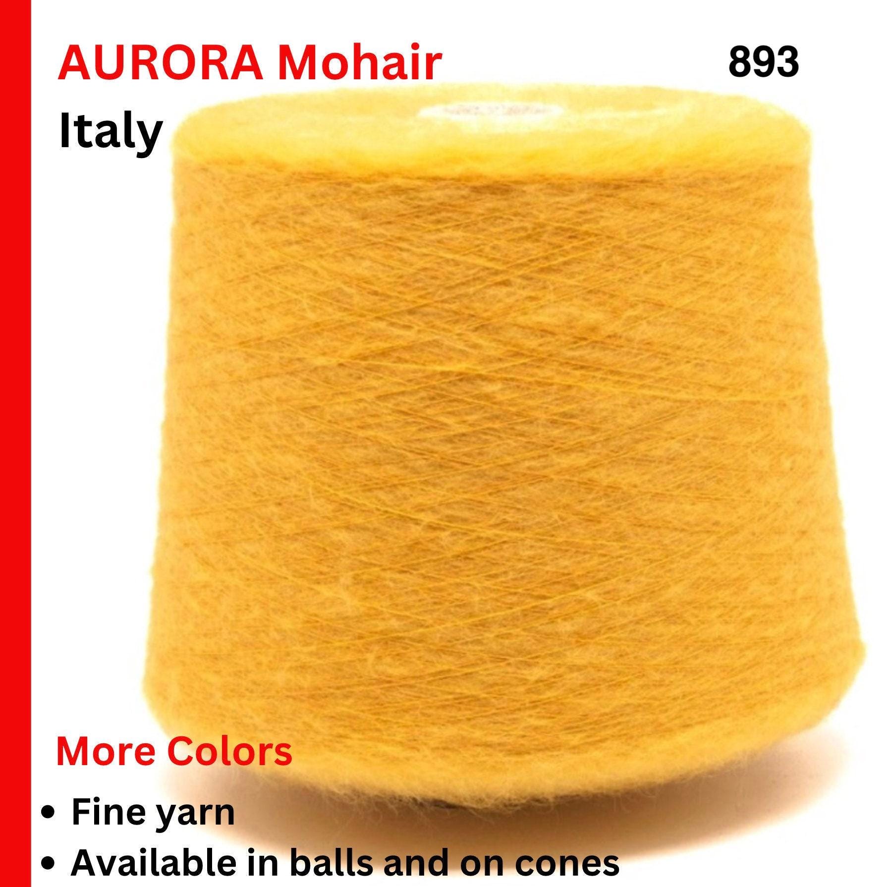 Yellow yarn cone with text about Aurora Mohair from Italy on a white background