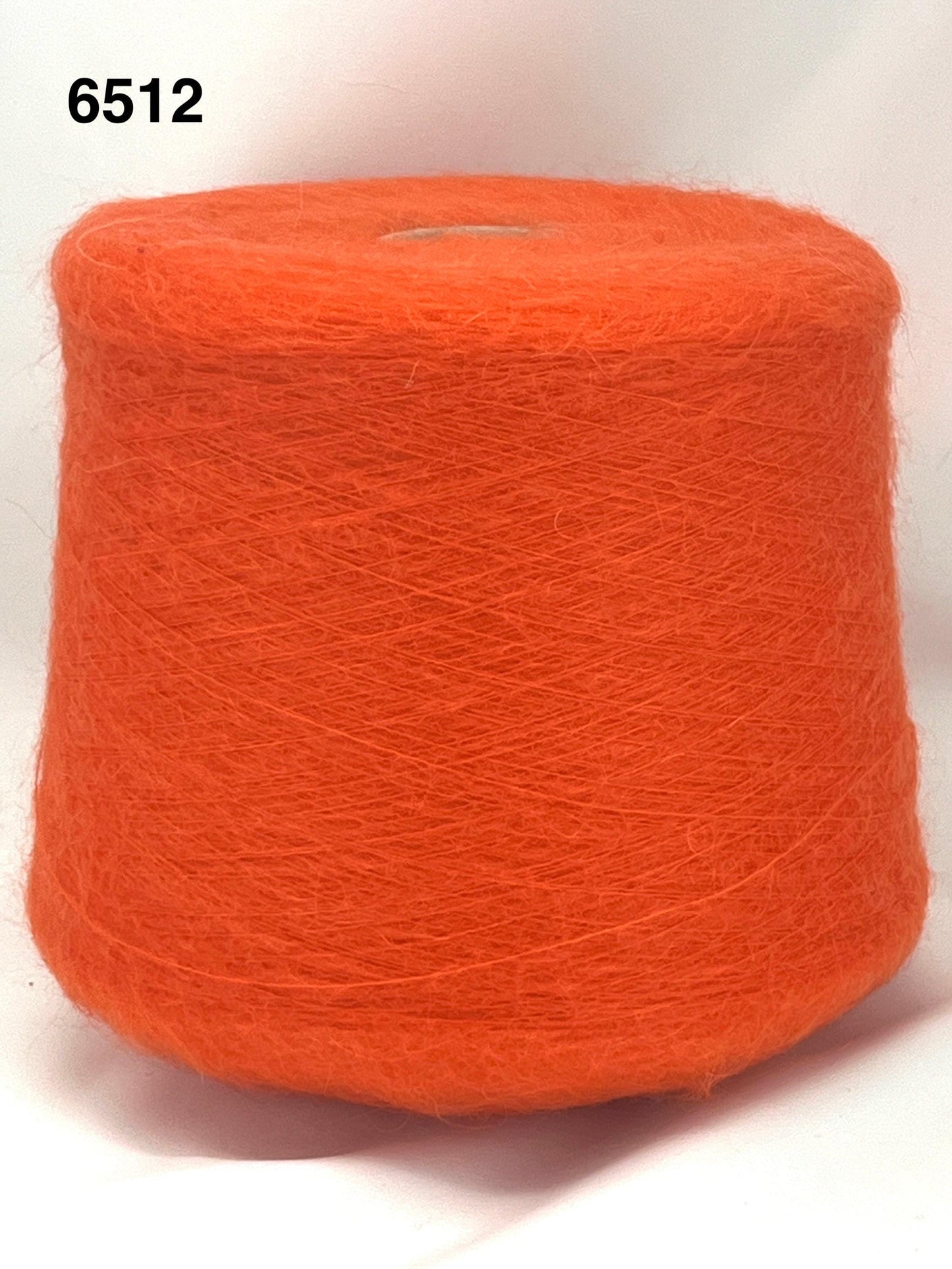 Orange spool of yarn on a white background