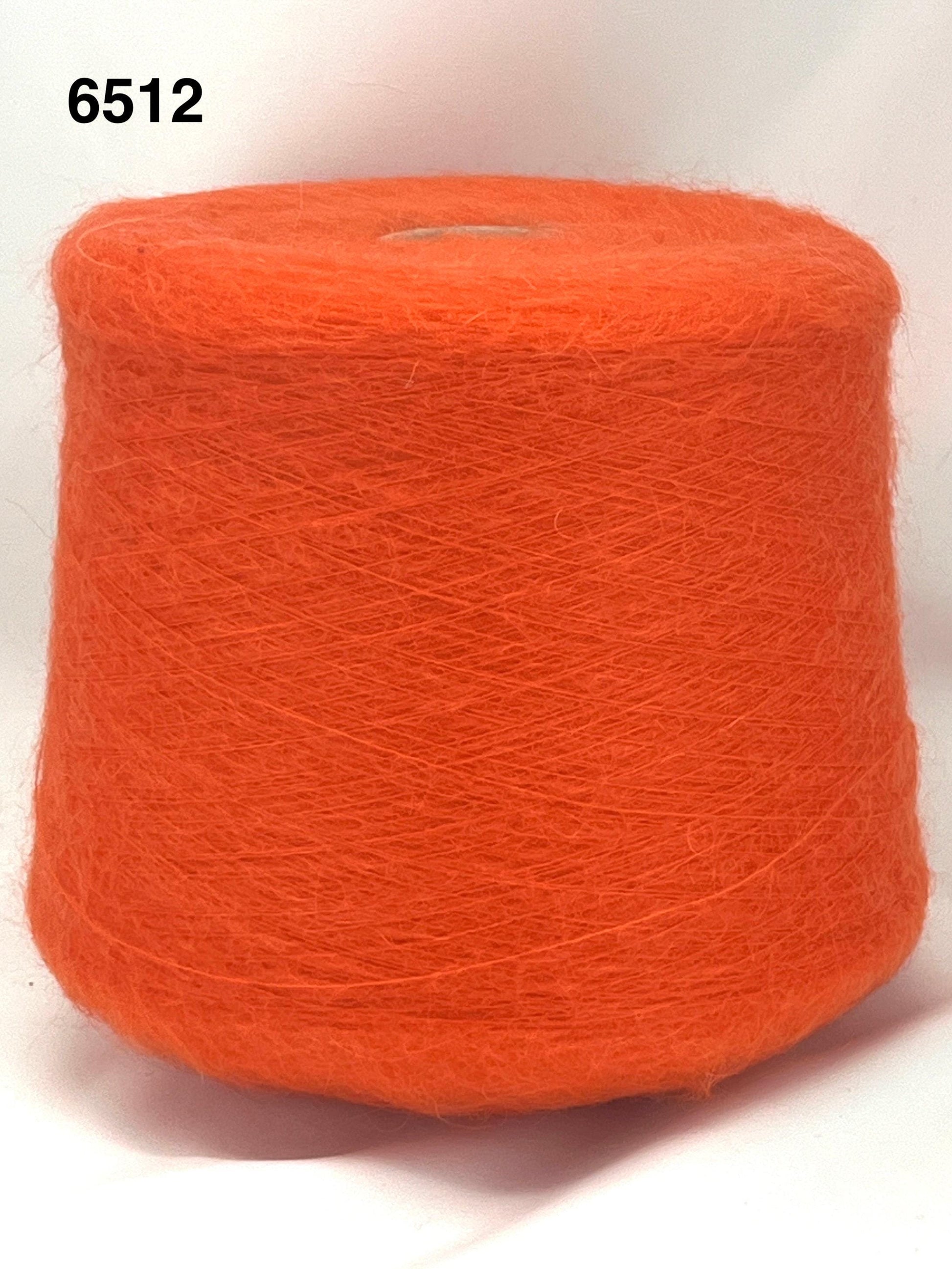 Orange spool of yarn on a white background