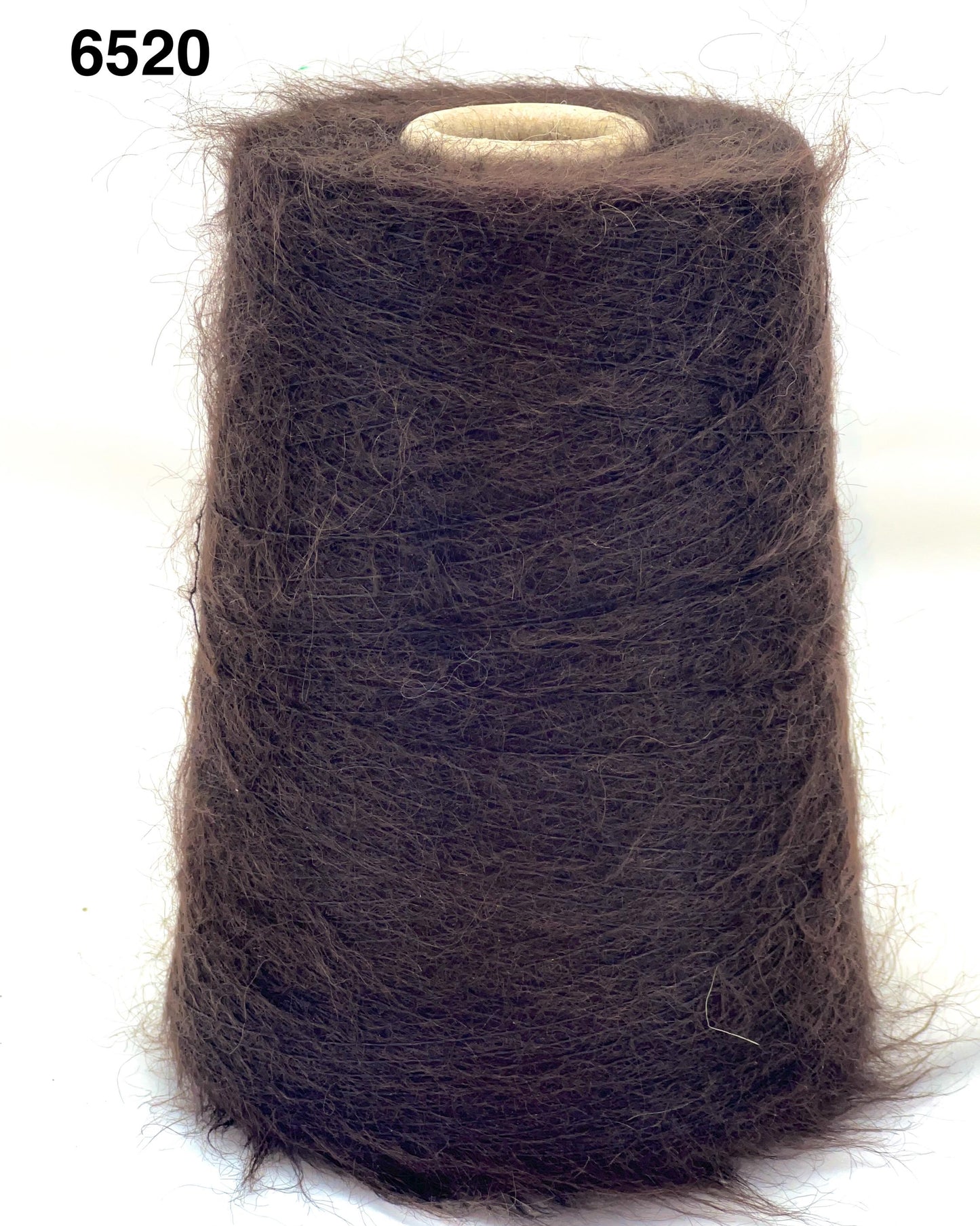 Spool of brown thread on a white background
