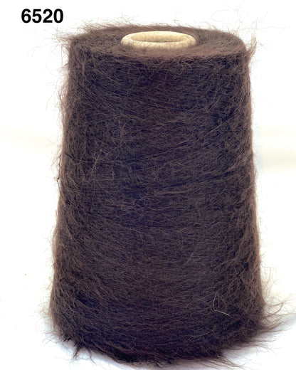 Spool of brown thread on a white background