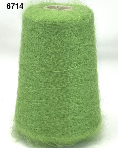 Green spool of yarn on a white background