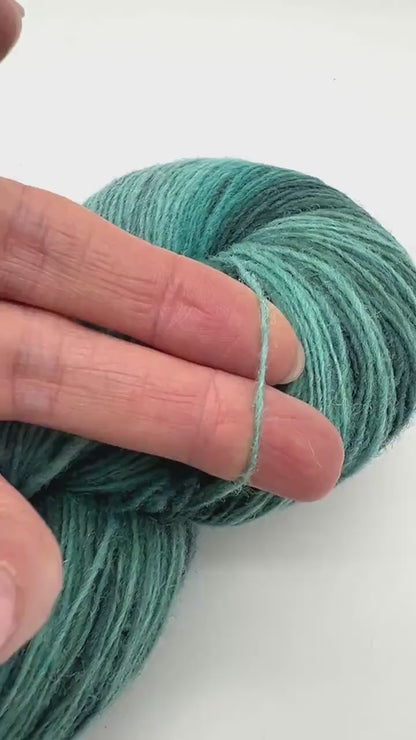 Exclusive iDOKNiT fingering weight heritage yarn, DUNDAGA 6.1 from Paces Vilnas Fabrika, Latvia. A traditional 6/1 single-ply blend of 70% Latvian wool and 30% Latvian merino, providing 460m per 100g. Curated by iDOKNiT in a spectrum of authentic blue and green Baltic shades (022, 023, 024, 054, 067, 069, 092) for rustic-refined knitwear with a soft, natural bloom.