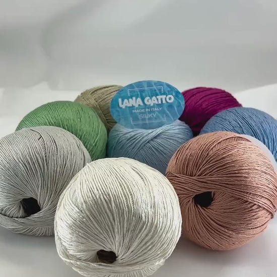 Lana Gatto SILKY pure silk yarn Italian fingering yarn
Luxury silk yarn for elegant summer knitwear and shawls
Close up of SILKY yarn showing smooth plied silk texture
Italian pure silk yarn with elegant sheen and drape
Soft breathable silk yarn for luxury knitting projects