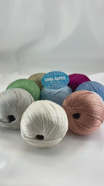 Lana Gatto SILKY pure silk yarn Italian fingering yarn
Luxury silk yarn for elegant summer knitwear and shawls
Close up of SILKY yarn showing smooth plied silk texture
Italian pure silk yarn with elegant sheen and drape
Soft breathable silk yarn for luxury knitting projects