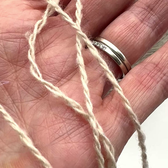 Gruppo Tessile Industriale WEB TWEED Italian cashmere yarn shown on professional cones. This 100% carded cashmere sport weight yarn features a subtle, modern tweed texture and soft loft. Premium luxury designer yarn available at iDOKNiT.com.