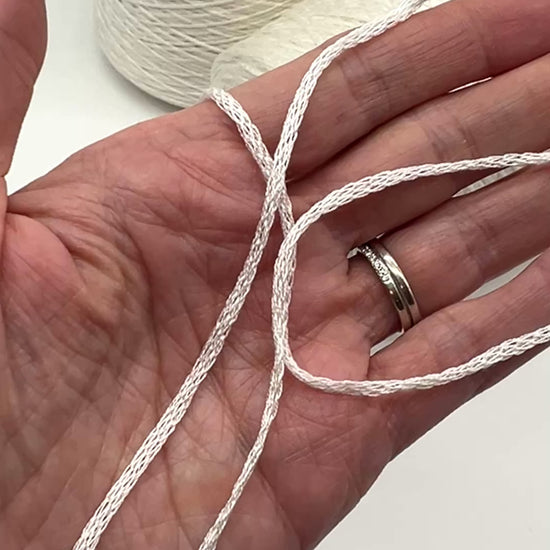 Luxury iDOKNiT fingering weight yarn, SETA SHAPPE by RiGo Italy. 100% Seta Shappe Silk featuring a sophisticated chainette structure for superior breathability and drape, 420m/100g. Authentic Italian-made silk on cones, color 2153 White, curated by iDOKNiT for elite hand and machine knitting projects.