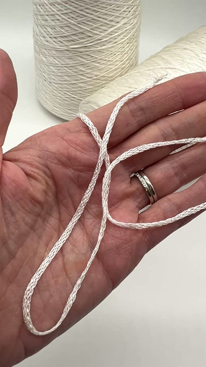 Luxury iDOKNiT fingering weight yarn, SETA SHAPPE by RiGo Italy. 100% Seta Shappe Silk featuring a sophisticated chainette structure for superior breathability and drape, 420m/100g. Authentic Italian-made silk on cones, color 2153 White, curated by iDOKNiT for elite hand and machine knitting projects.