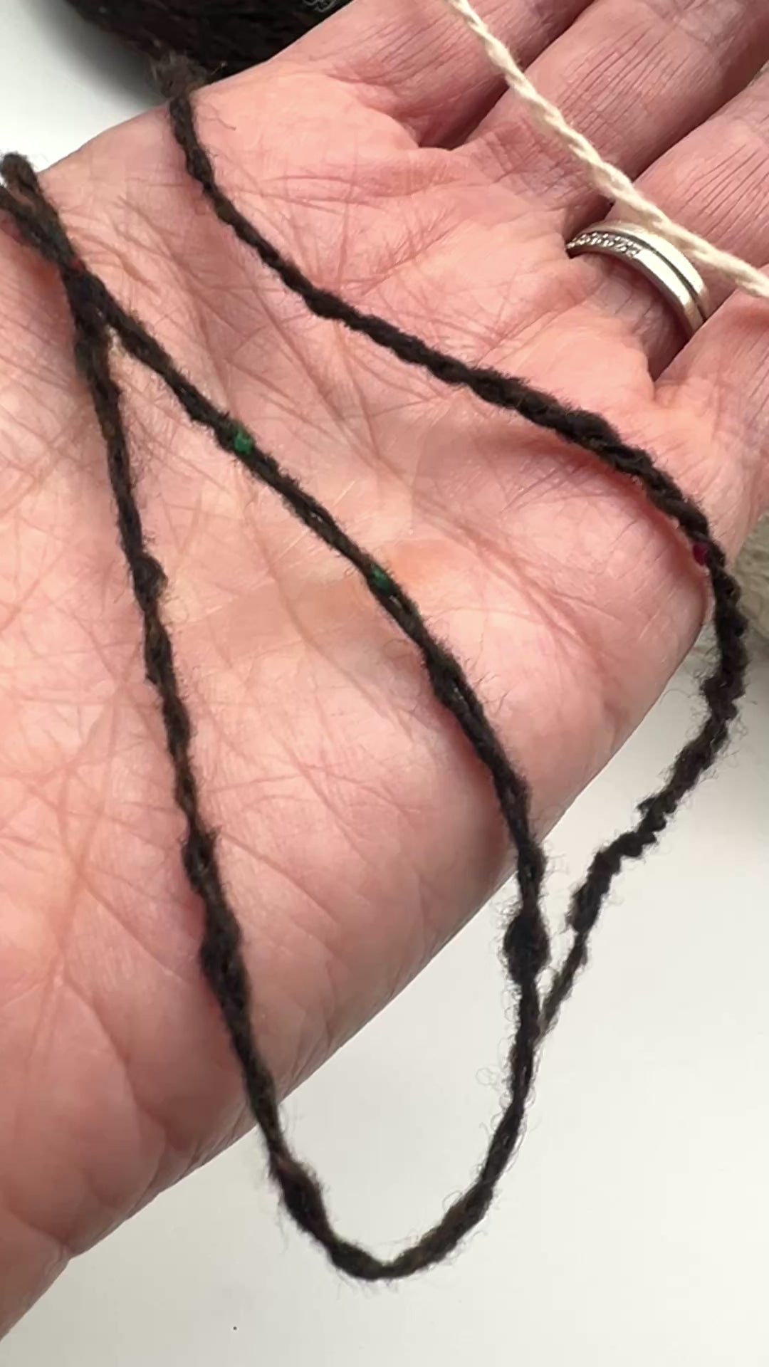 Gruppo Tessile Industriale WEB TWEED Italian cashmere yarn shown on professional cones. This 100% carded cashmere sport weight yarn features a subtle, modern tweed texture and soft loft. Premium luxury designer yarn available at iDOKNiT.com.