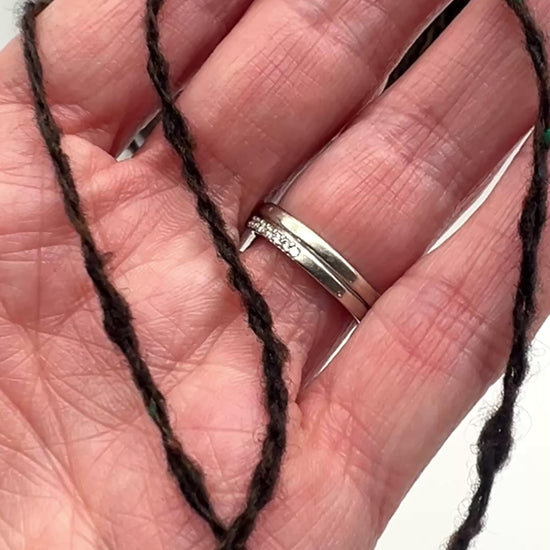 Gruppo Tessile Industriale WEB TWEED Italian cashmere yarn shown on professional cones. This 100% carded cashmere sport weight yarn features a subtle, modern tweed texture and soft loft. Premium luxury designer yarn available at iDOKNiT.com.