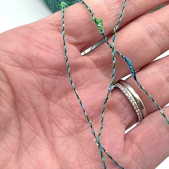 Exclusive iDOKNiT RiGo NODINO lace yarn featuring a radiant 67% viscose and 7% Lurex blend with a decorative Shishibriki texture for sophisticated Italian knitwear.