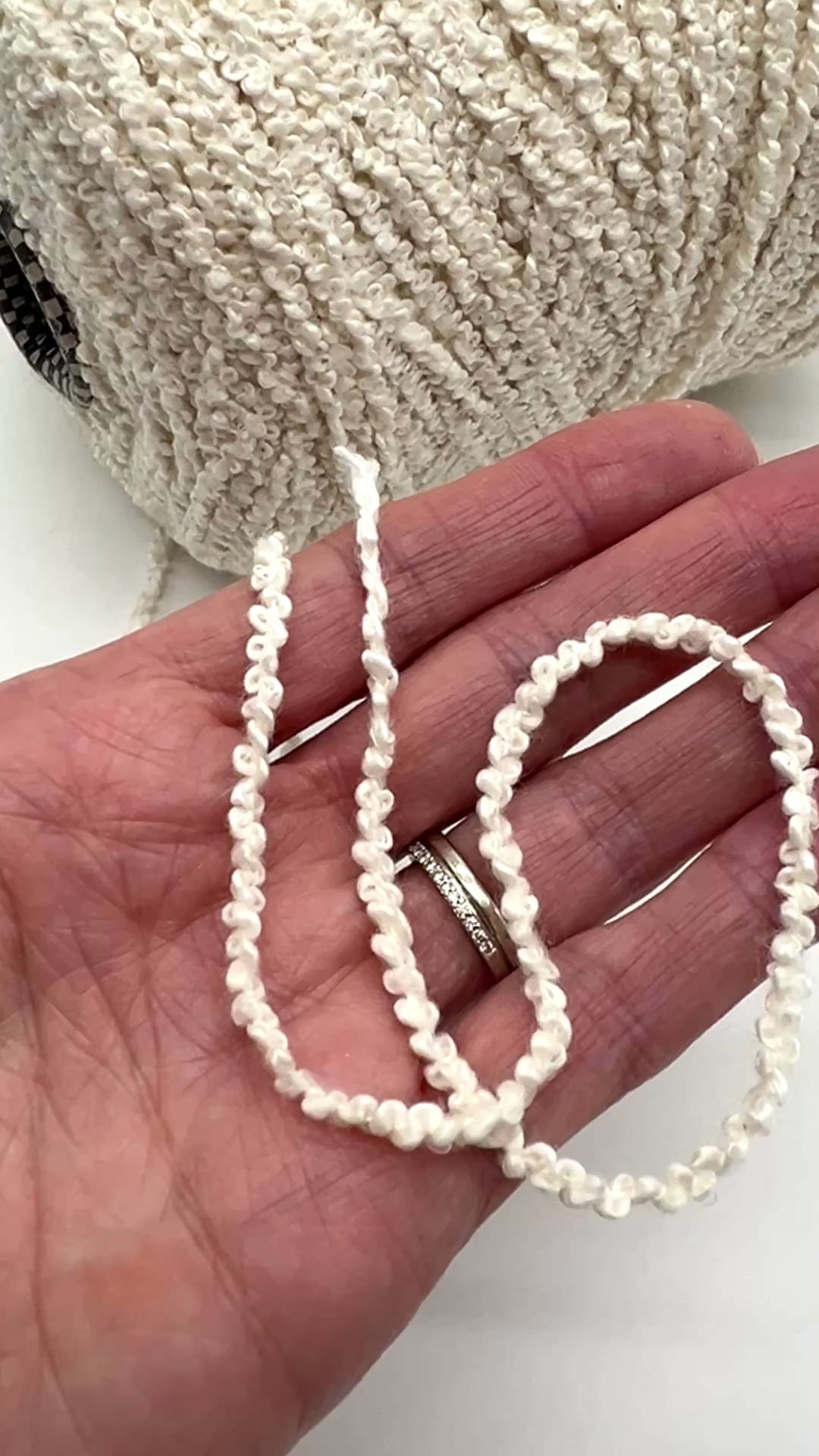 Italian cotton bouclé yarn on cone with looped textured surface