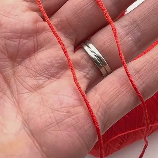 Luxury COTTON SILK lace-weight yarn by Botto Giuseppe, Italy – 55% silk and 45% cotton blend, super soft with an elegant natural sheen. Shown in vibrant coral red on a cone. Ideal for summer tops, lightweight layering, and luxury blending. Premium Italian yarn available at iDOKNiT.com.