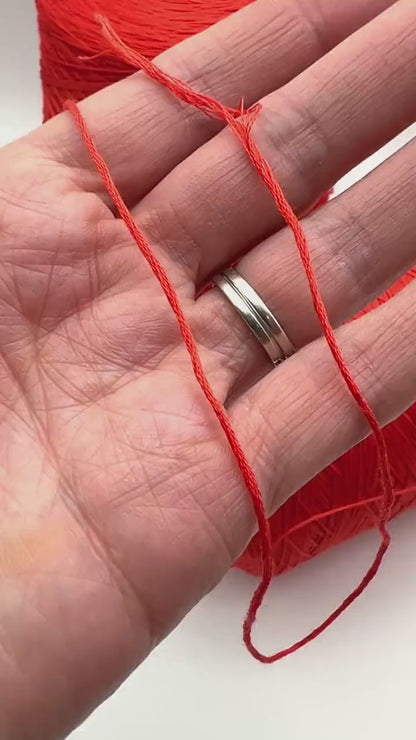 Luxury COTTON SILK lace-weight yarn by Botto Giuseppe, Italy – 55% silk and 45% cotton blend, super soft with an elegant natural sheen. Shown in vibrant coral red on a cone. Ideal for summer tops, lightweight layering, and luxury blending. Premium Italian yarn available at iDOKNiT.com.