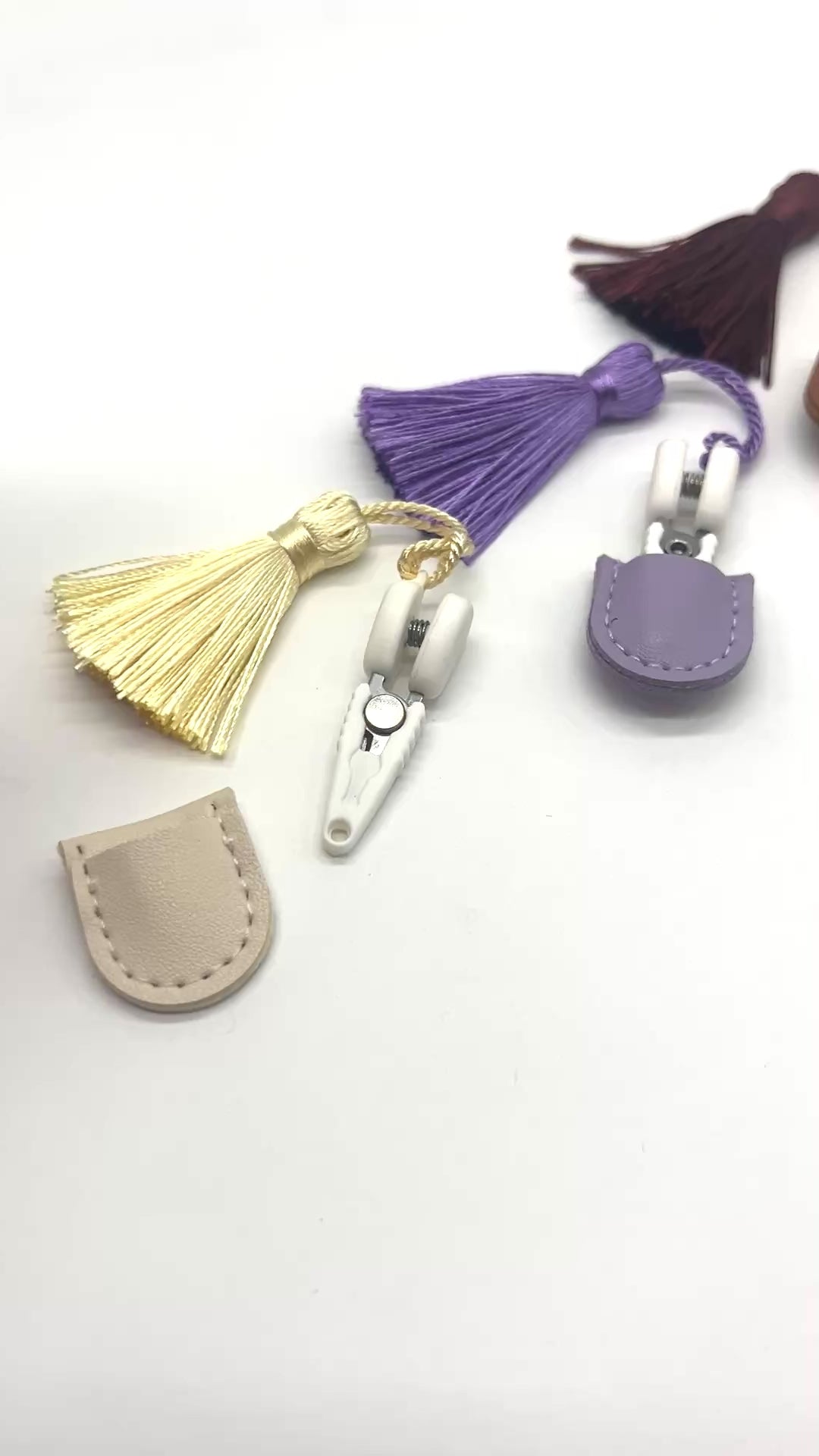 Professional iDOKNiT mini precision thread scissors for crafters. These 42mm spring-style snips feature a decorative tassel and protective cover, designed for sharp, precise trimming of yarn and embroidery floss. Compact and travel-ready accessory curated by iDOKNiT for knitting, crochet, and sewing project bags.