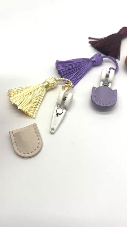 Professional iDOKNiT mini precision thread scissors for crafters. These 42mm spring-style snips feature a decorative tassel and protective cover, designed for sharp, precise trimming of yarn and embroidery floss. Compact and travel-ready accessory curated by iDOKNiT for knitting, crochet, and sewing project bags.