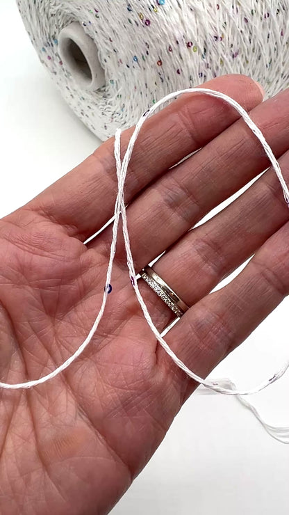 Professional grade RiGo STELLATO sport weight yarn from iDOKNiT, featuring a sophisticated 60% Italian cotton base with 2mm integrated paillettes. This authentic Italian-made yarn is curated by iDOKNiT to provide a refined shimmer and luxury finish for elegant, high-performance knitting projects.